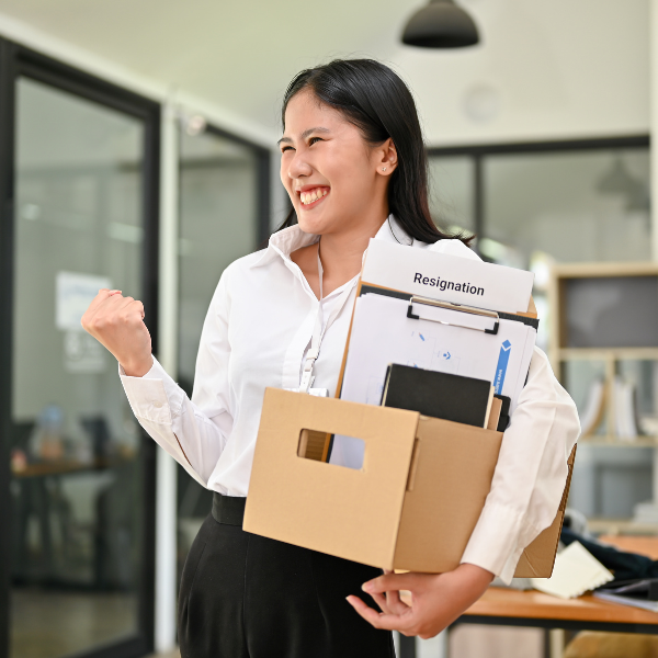 Happy office worker expressing joy and relief after resigning from her job.
