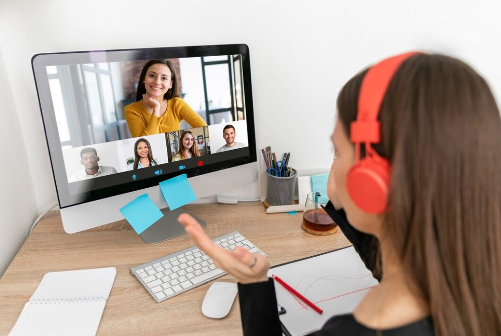 A remote team engaging in a virtual icebreaker activity, with team members smiling and interacting through a video call.