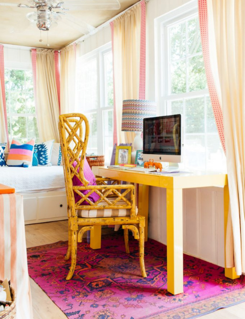 A cozy bohemian-style office with macrame, woven textures, and neon accents in throws, rugs, and small décor pieces for an eclectic touch.