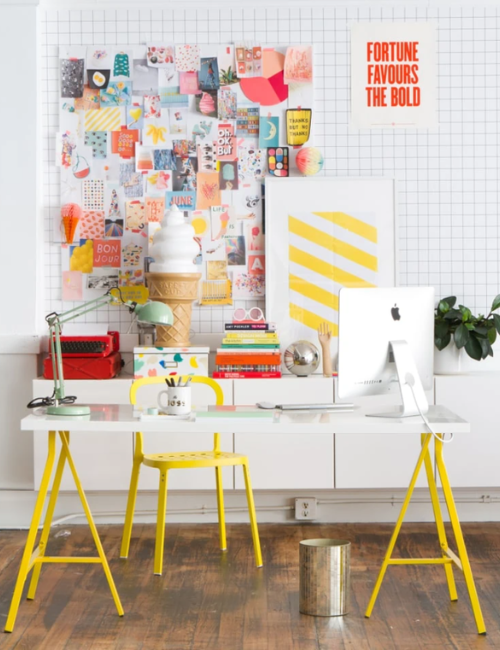 A neon-themed inspiration board filled with colorful notes, bold push pins, and motivational quotes, adding a vibrant energy to the office.