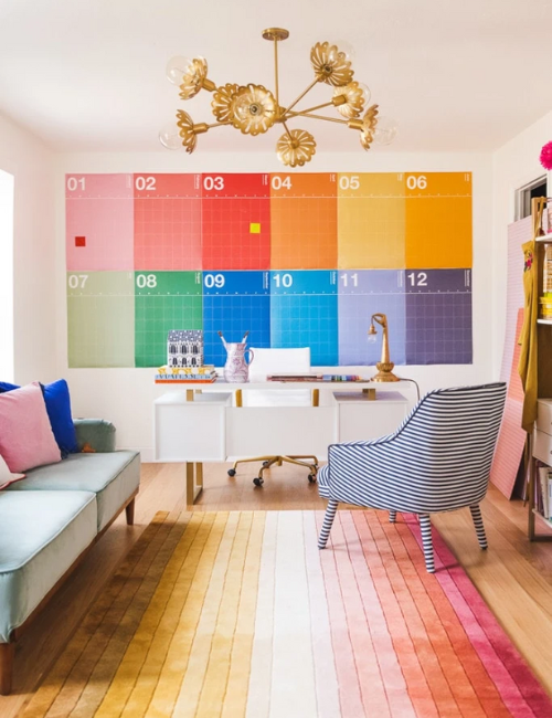 A striking, multicolored feature wall sets a dynamic backdrop, energizing the office while complementing neutral furniture and décor.