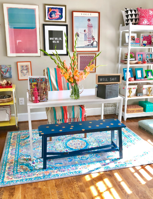 A mix of neon-framed artwork, vibrant typography prints, and modern LED neon signs creating an artistic and inspiring workspace.